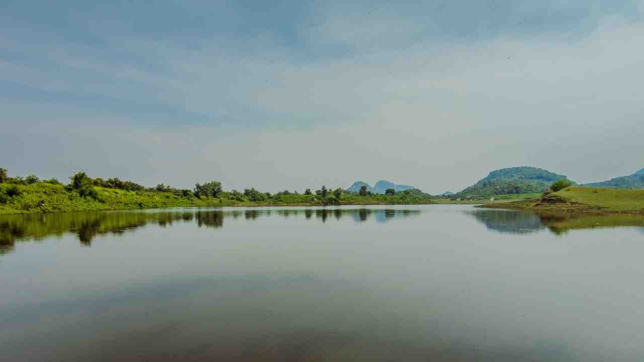 Beautiful lakeside scenery at Soorwal Dam with lush greenery around the water