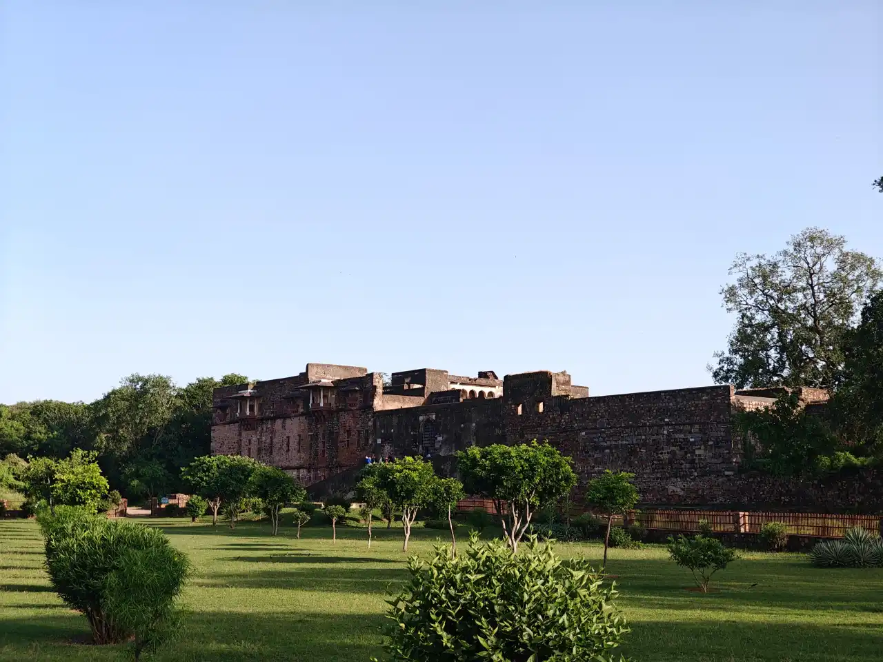 Ruined arches of the Ranthambore Fort King Palace overlooking the green valley below